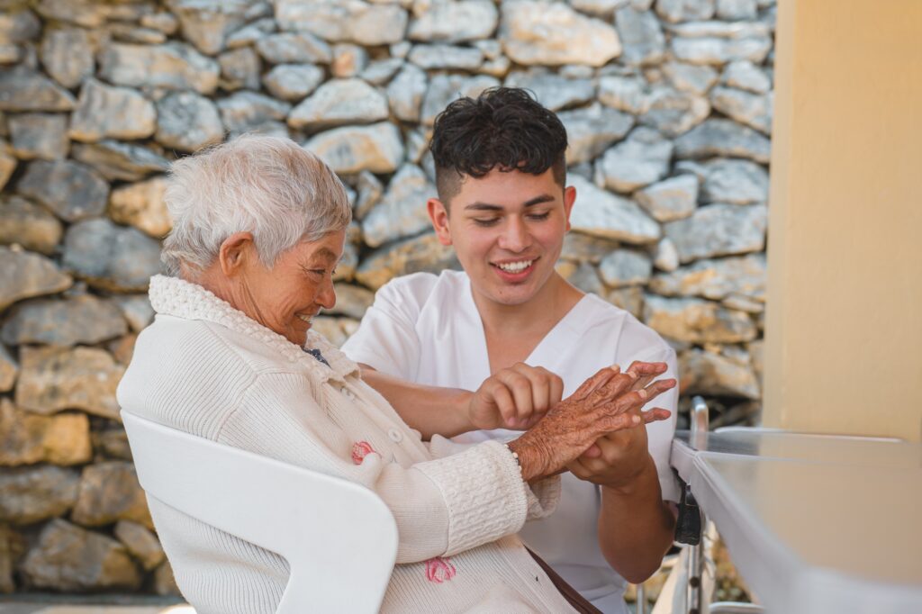 Caregiver Assisting Elderly Woman Outdoors, Depicting Compassion and Support