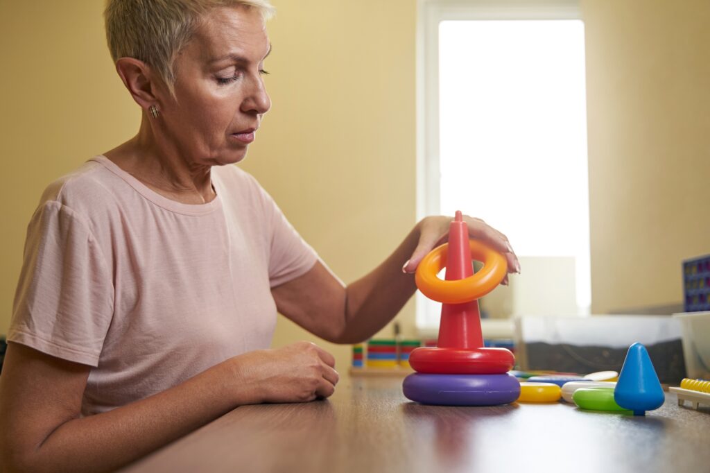 Photo of ergotherapy with stroke woman in rehab center