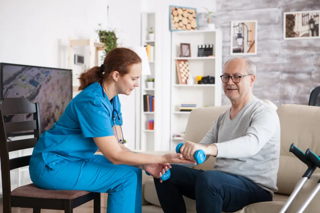 Female nurse doing physiotherapy with senior man