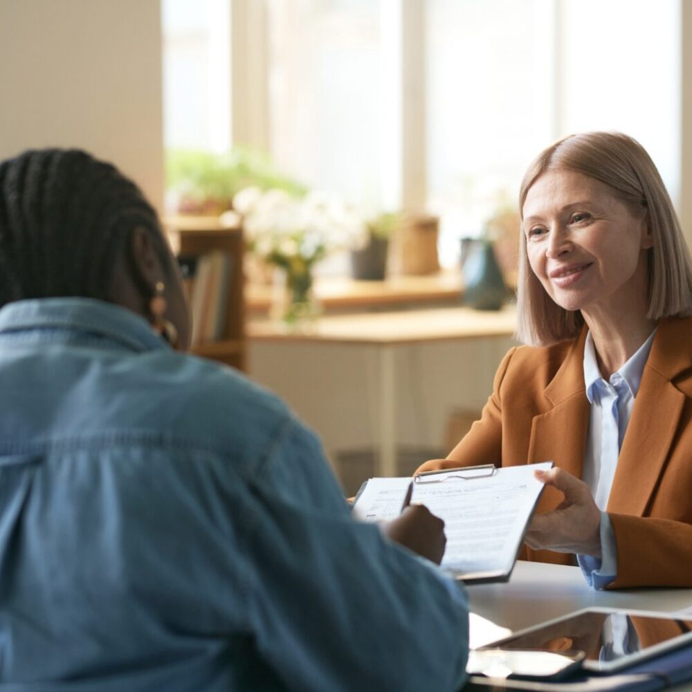 Insurance Agent Giving Agreement to Clients